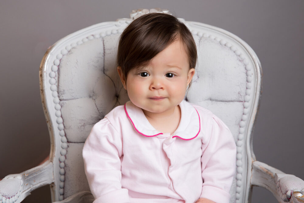 little-girl-sitting-on-chair-by-surrey-baby-photographer