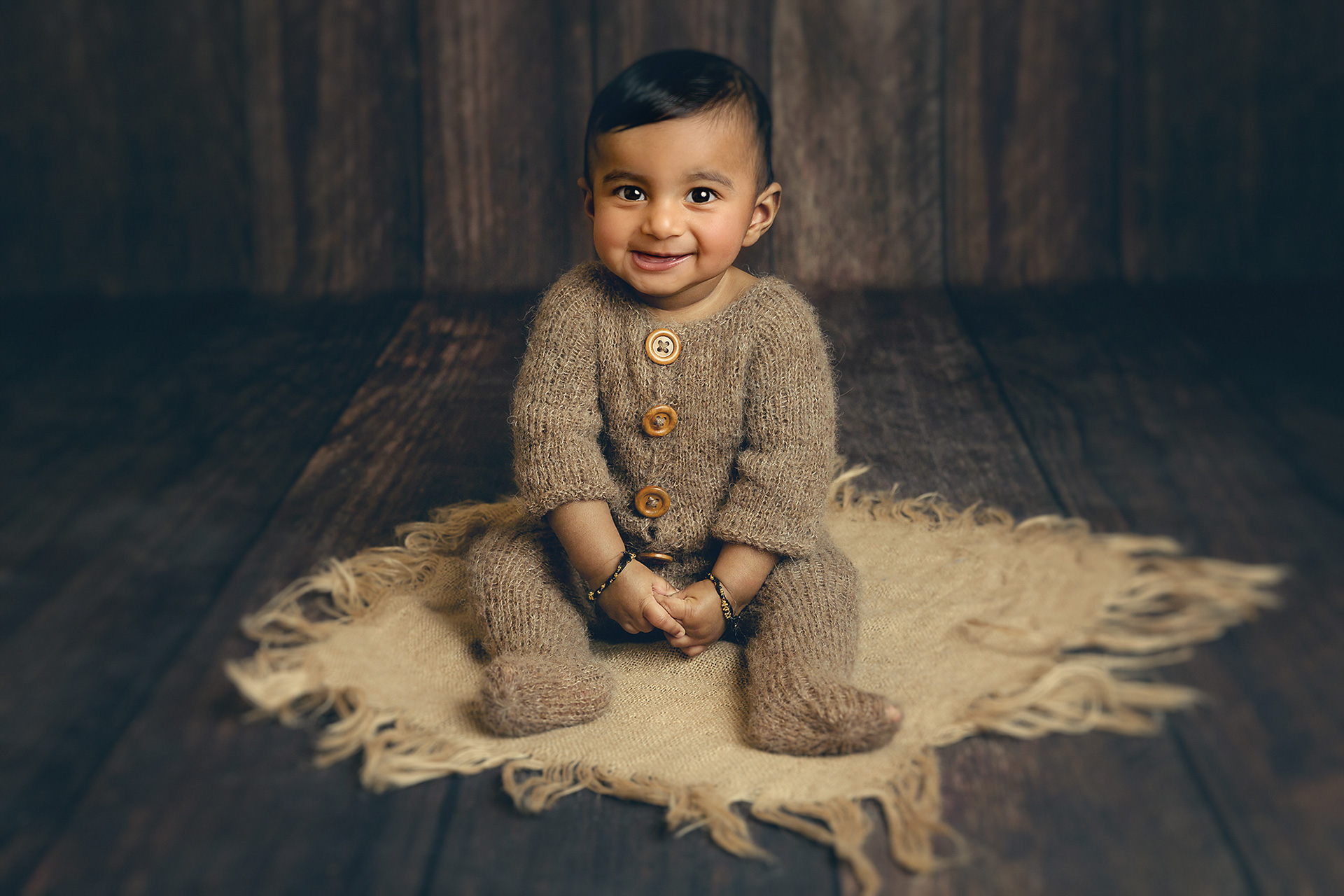little baby boy sitting smiling by Surrey Newborn Photographer